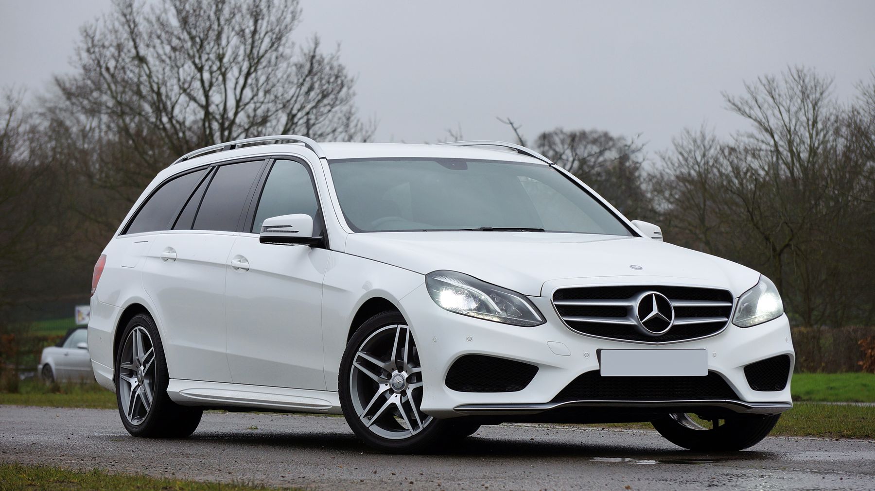 White Mercedes-Benz E-Class wagon, three-quarter front view