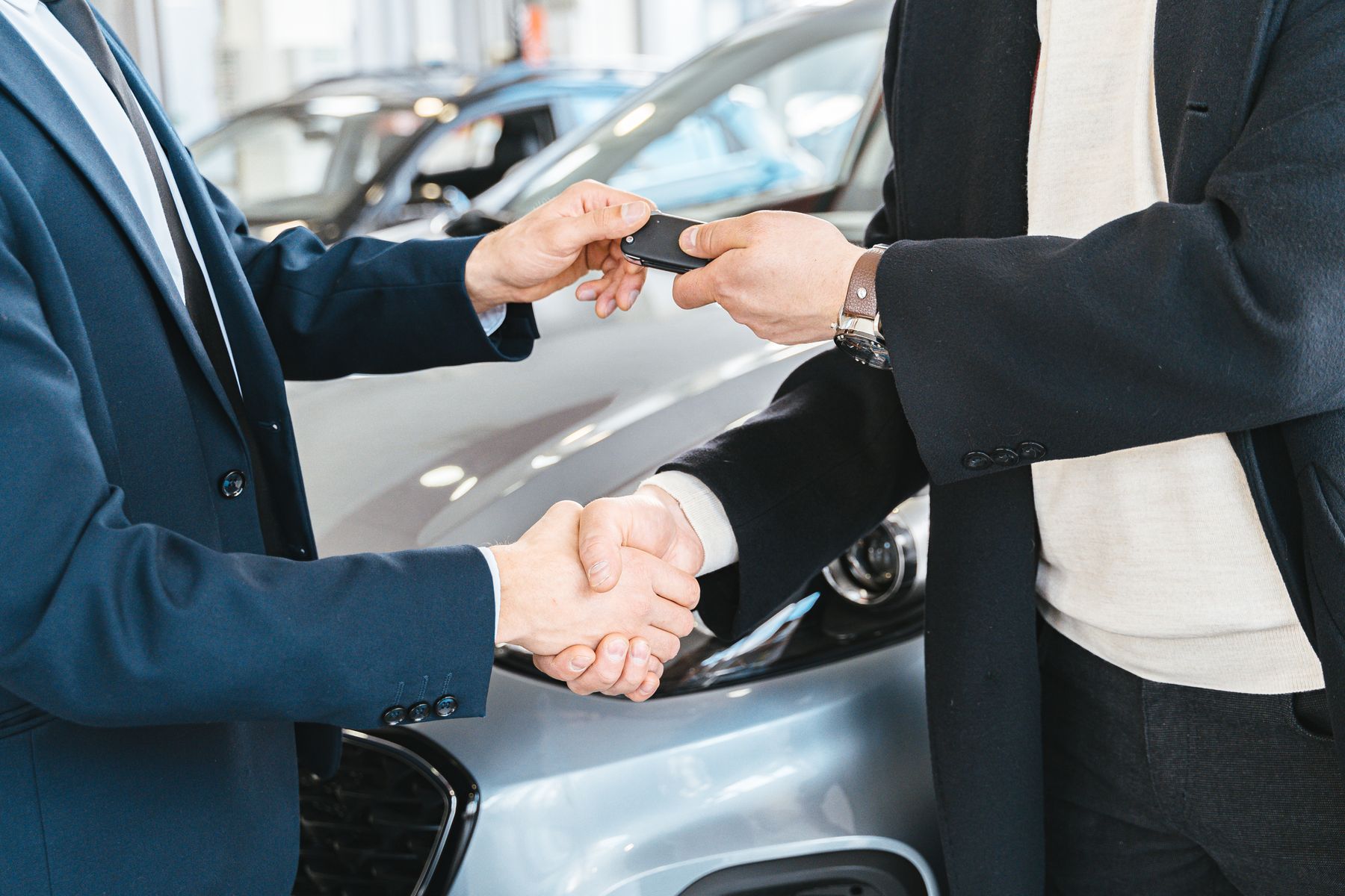 A key handover between two people, hands only